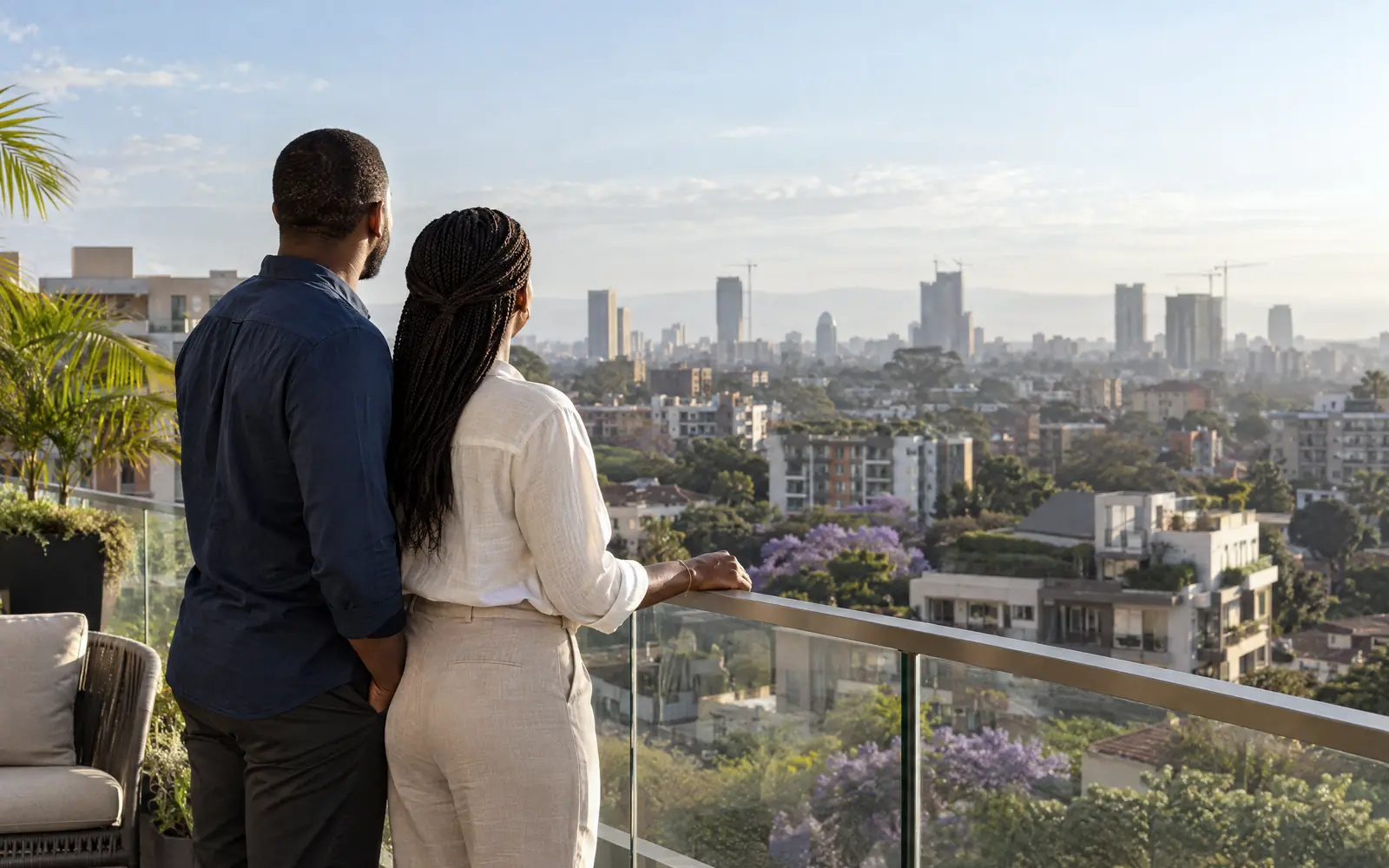 A couple looking out over Nairobi from a rooftop terrace